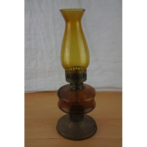 220 - A vintage amber glass oil lamp and shade.