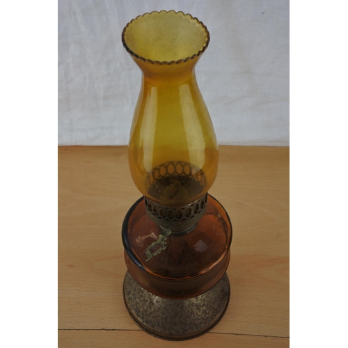 220 - A vintage amber glass oil lamp and shade.