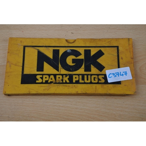 223 - A vintage NGK Spark Plug advertising sign. Approx 10x20cm.