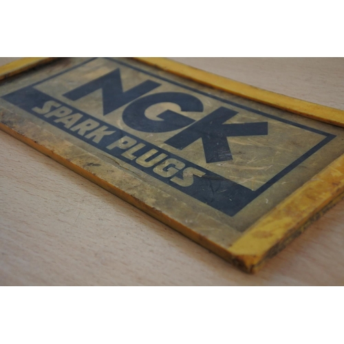 223 - A vintage NGK Spark Plug advertising sign. Approx 10x20cm.