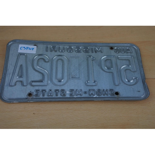 232 - A vintage pressed American Licence Plate.