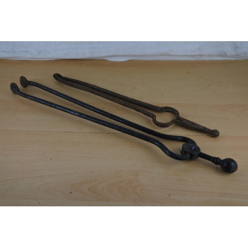 233 - Two vintage fire tongs.