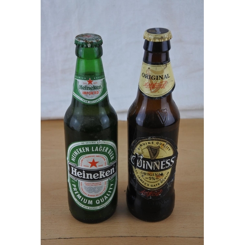 234 - An unopened bottle of Heineken beer and a bottle of Guinness (seal broken).