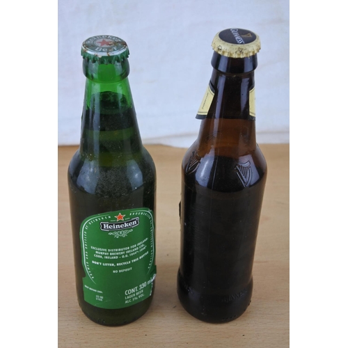 234 - An unopened bottle of Heineken beer and a bottle of Guinness (seal broken).