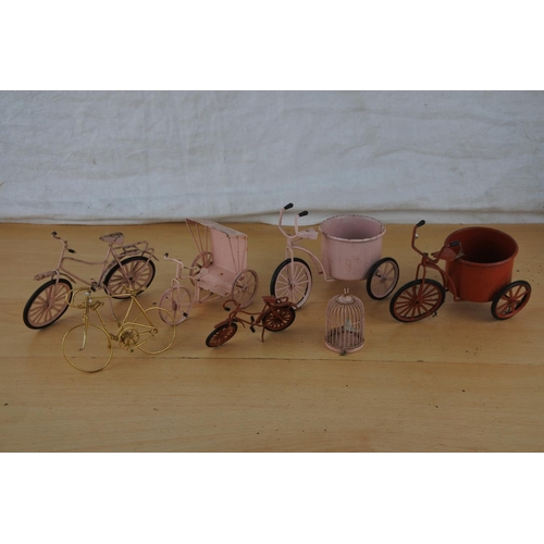 237 - A collection of miniature bicycles and a bird cage.