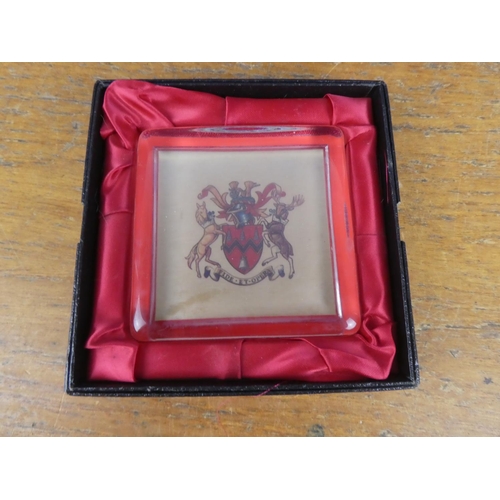 306 - A large boxed glass paperweight with crest.