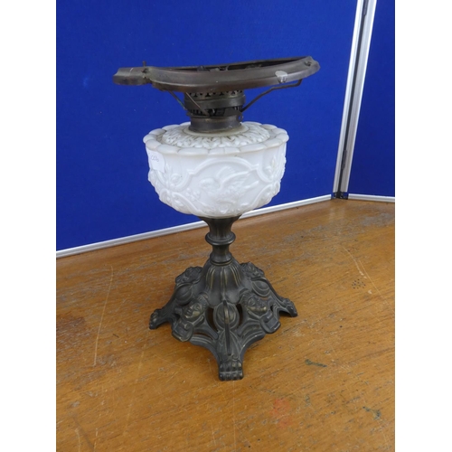 334 - A stunning antique oil lamp base with milk glass font decorated with birds. Approx 37cm.