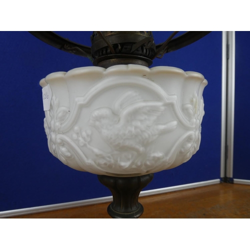 334 - A stunning antique oil lamp base with milk glass font decorated with birds. Approx 37cm.