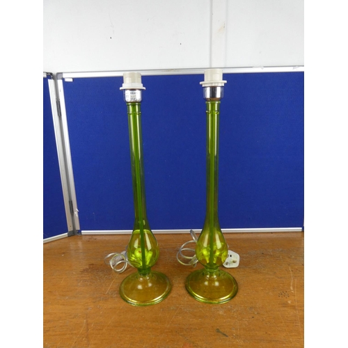 335 - An unusual pair of tall green glass lamp bases. Approx 55cm.