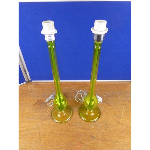 335 - An unusual pair of tall green glass lamp bases. Approx 55cm.