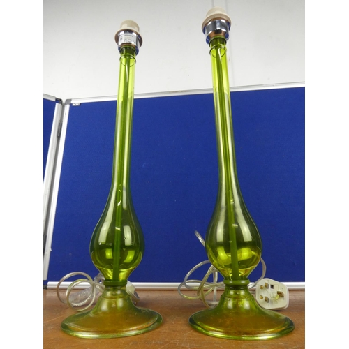 335 - An unusual pair of tall green glass lamp bases. Approx 55cm.