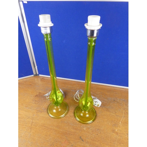 335 - An unusual pair of tall green glass lamp bases. Approx 55cm.