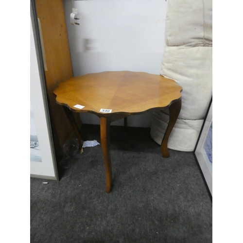 340 - A vintage scalloped edge coffee table.