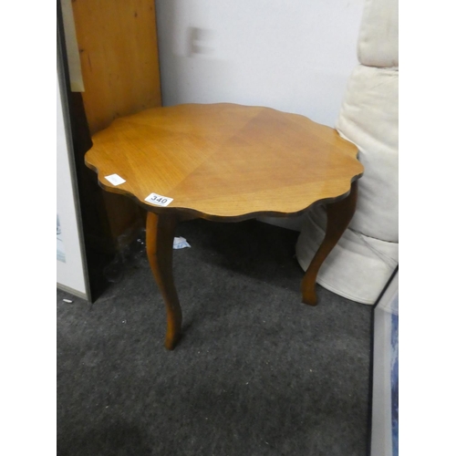 340 - A vintage scalloped edge coffee table.