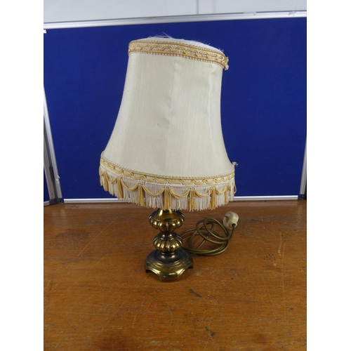 344 - A vintage brass based table lamp and shade.