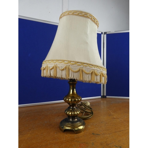 344 - A vintage brass based table lamp and shade.