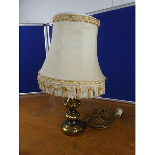 344 - A vintage brass based table lamp and shade.