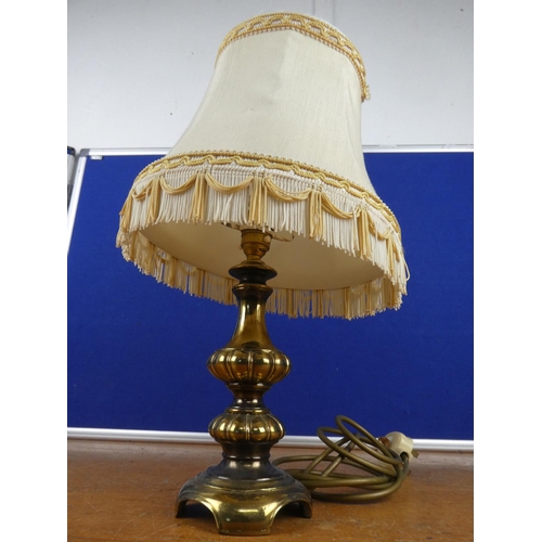 344 - A vintage brass based table lamp and shade.