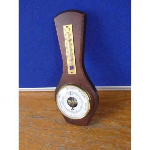 389 - A small mahogany wall mounted barometer.