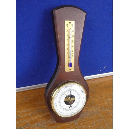 389 - A small mahogany wall mounted barometer.