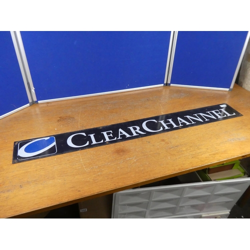 392 - A vintage 'Clear Channel' metal advertising sign. Approx 124x15cm.