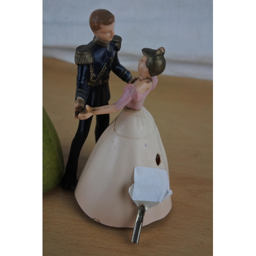 402 - A vintage Disney Cinderella & Prince charming clockwork figure & another.