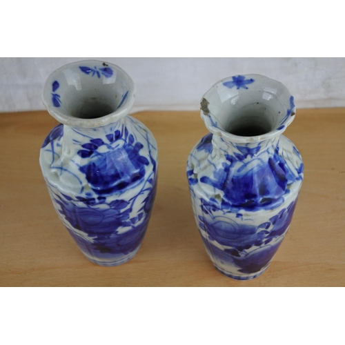 406 - A pair of antique Oriental/ Chinese blue and white vases (a/f).