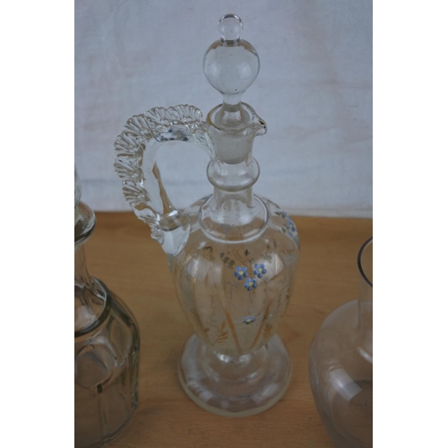 410 - A stunning antique glass decanter with hand painted detail, another decanter and a glass vase,