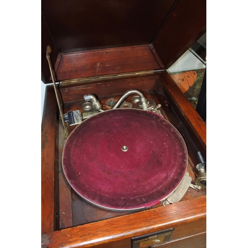 414 - A mahogany cased 'His Master's Voice' gramophone (a/f) with a box of various gramophone parts. Appro... 