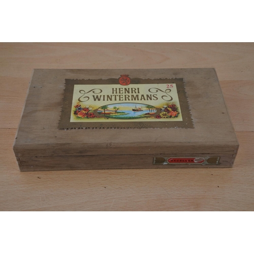 432 - A Henri Wintermans cigar box and a lot of assorted coinage, all in presentation wallets.