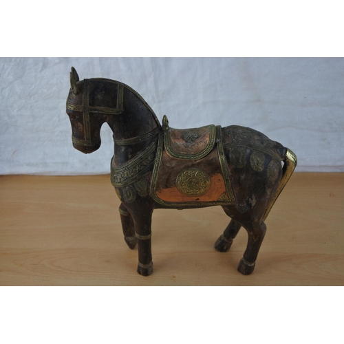 433 - An ornamental wooden horse with copper and brass detail.