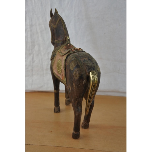 433 - An ornamental wooden horse with copper and brass detail.