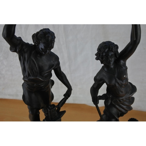 452 - A pair of metal figures on wooden plinths, stamped ASCO Approx 50cm.