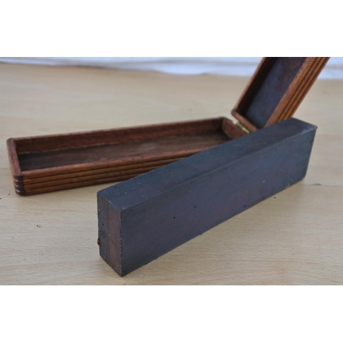 453 - A wooden cased sharpening stone.