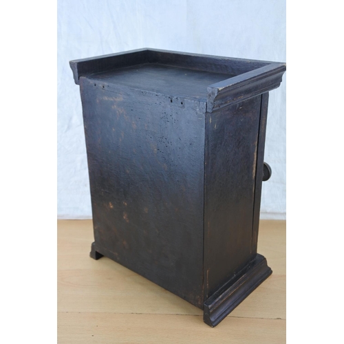 454 - A small wooden storage cupboard with cast iron lattice door. Approx 35cm.