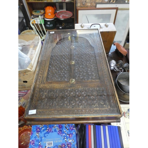 506 - A stunning oak carved coffee table with glass top. Approx 36x86cm.