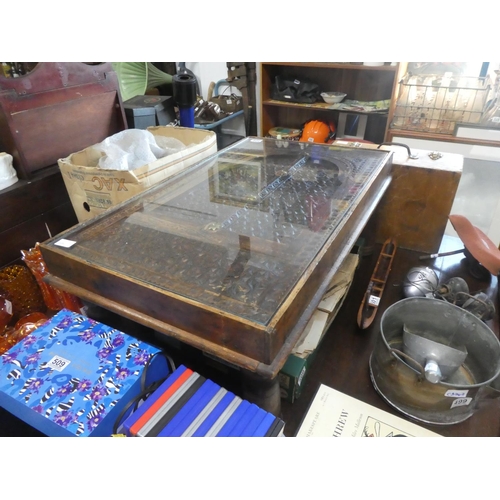 506 - A stunning oak carved coffee table with glass top. Approx 36x86cm.