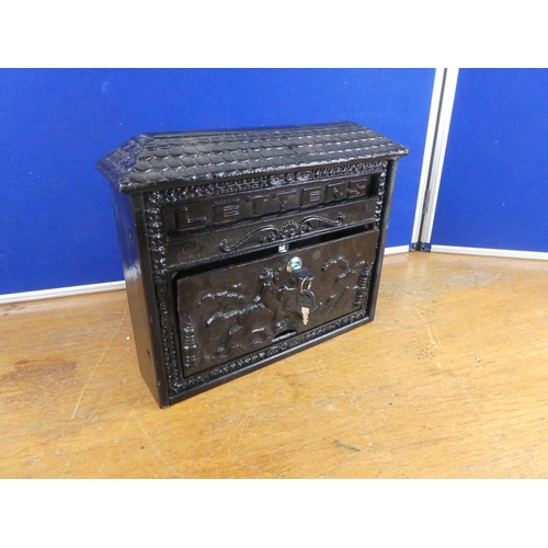 534 - A cast iron letter box and key. Approx 35x31cm.