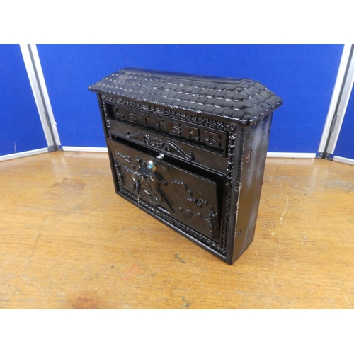 534 - A cast iron letter box and key. Approx 35x31cm.