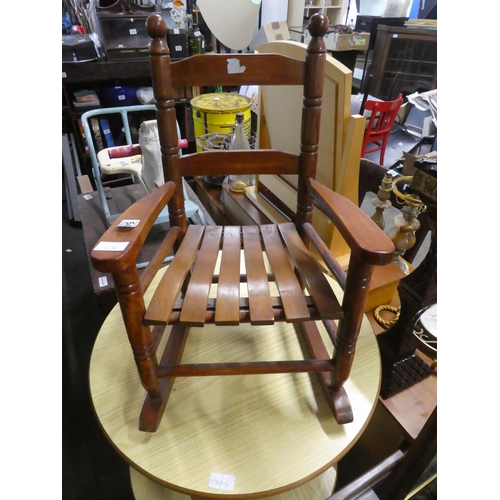 543 - A miniature wooden framed rocking chair' Approx  55cm.