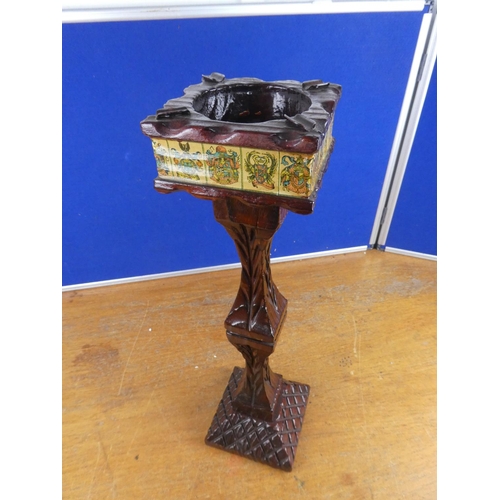 553 - A floor standing wooden ashtray with crested detail. Approx  56cm.