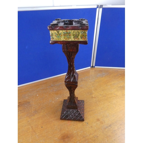 553 - A floor standing wooden ashtray with crested detail. Approx  56cm.