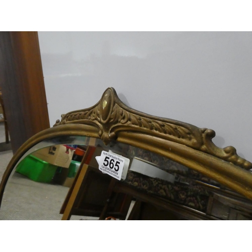 565 - An antique oval wall mirror with a gilt metal frame.  Approx  50x70cm.