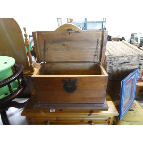 572 - A small pine storage trunk with metal work detail.