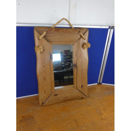 577 - A pine framed wall mirror with rope detail.  Approx  60x40cm.