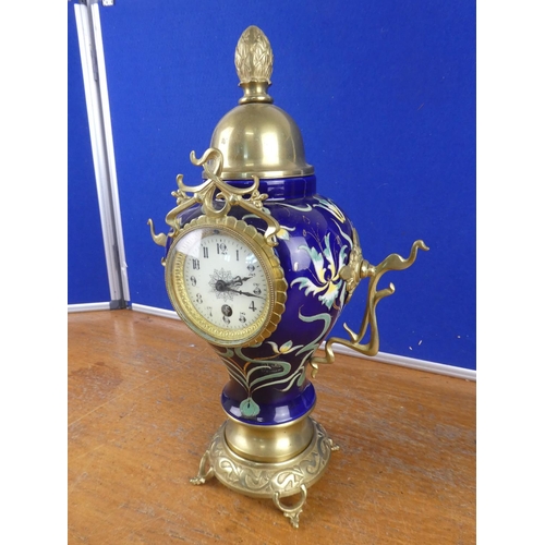 580 - A stunning French ceramic mantle clock with brass detail.