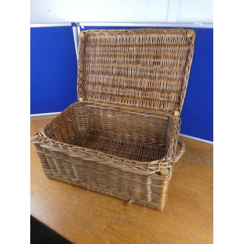 585 - A wicker storage/picnic basket.  Approx  26x56cm.