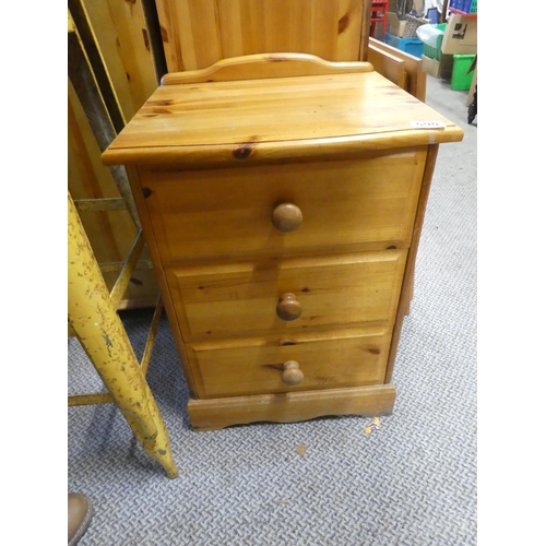 590 - A pine three drawer bedside cabinet.  Approx  59x43cm.