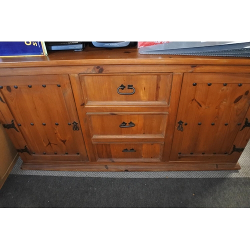 603 - A pine two door, three drawer sideboard with ironwork detail.  Approx  86x166x46cm.