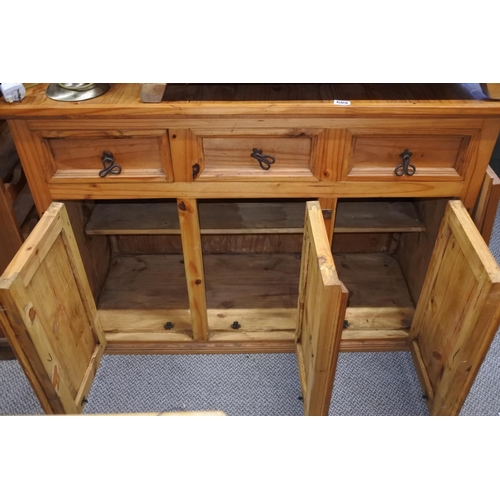 609 - A pine sideboard with ironwork hinges and handles.  Approx  90x124x49cm.